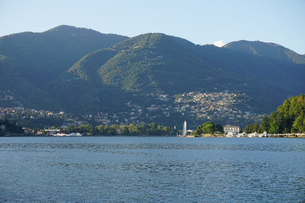 green mountain near body of water during daytime