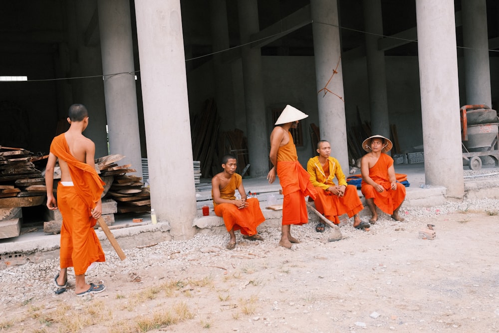 group of people sitting on gray concrete floor during daytime