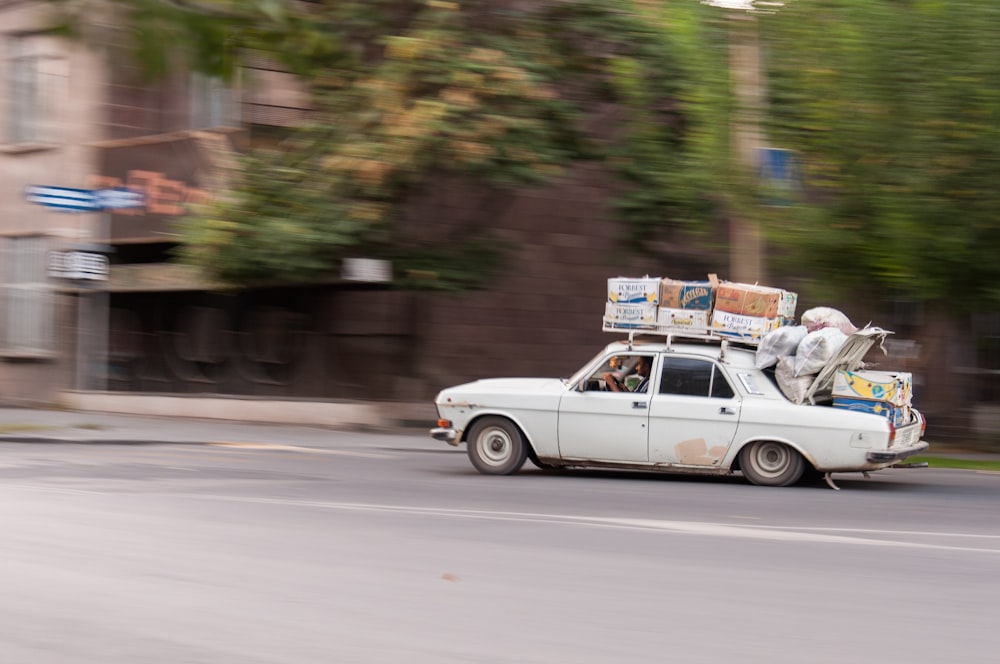 white sedan on road during daytime