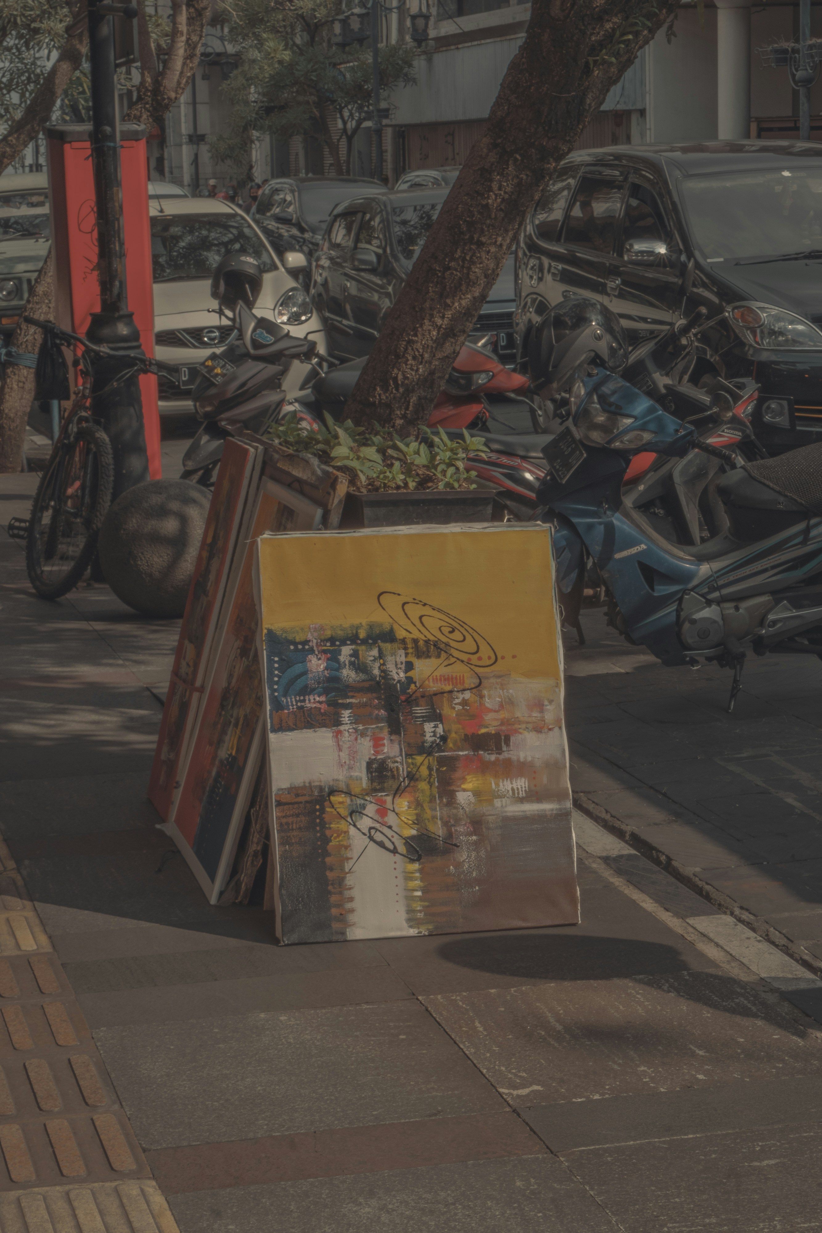black motorcycle parked beside brown tree trunk