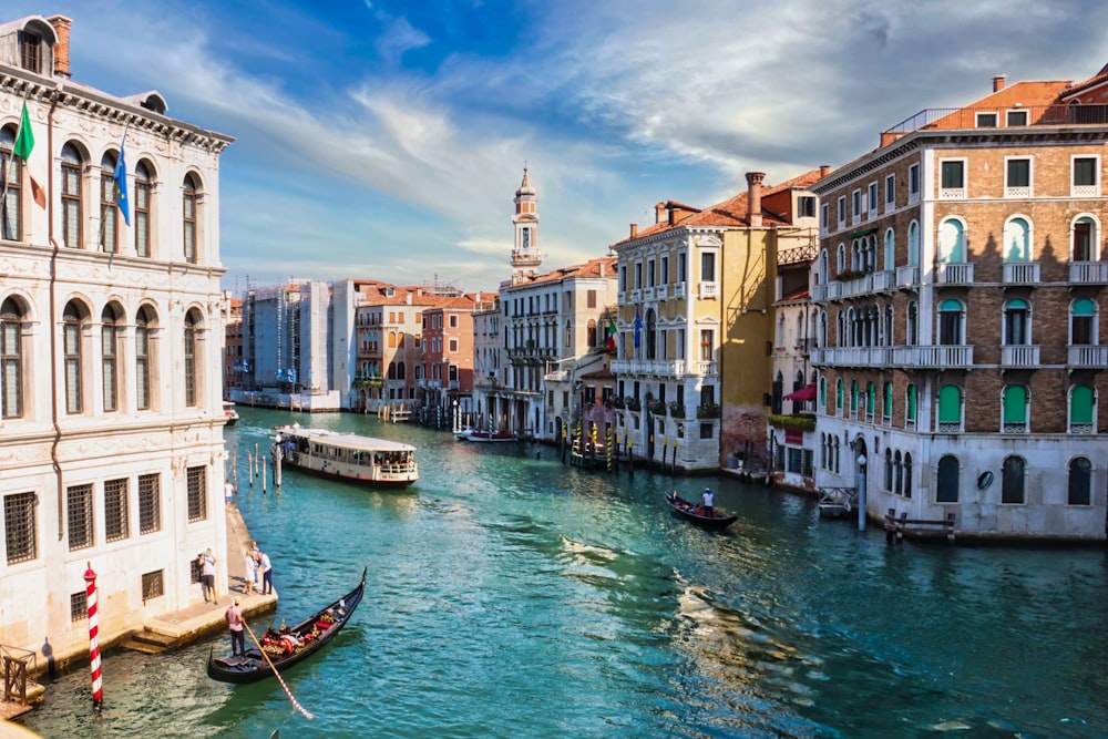 boat on water between buildings during daytime