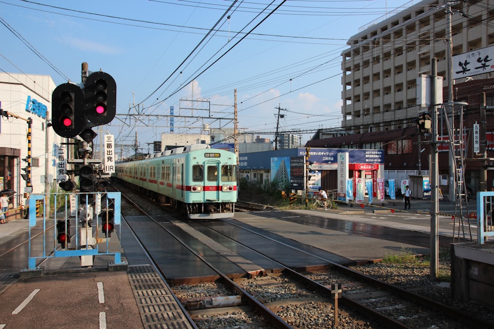 white and green train on rail road during daytime