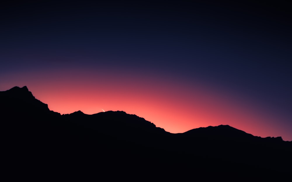 silhouette of mountain during sunset