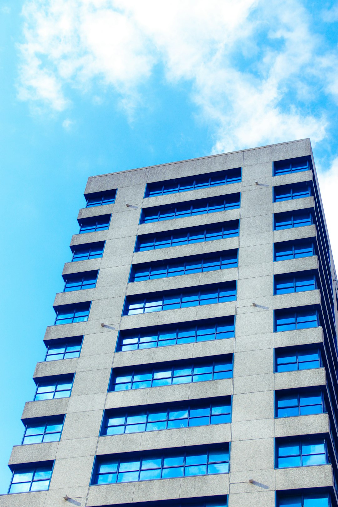 blue and white concrete building under blue sky during daytime