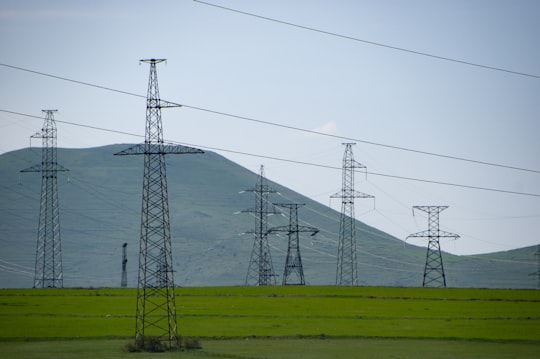 green grass field near mountain under white sky during daytime in Syunik Armenia