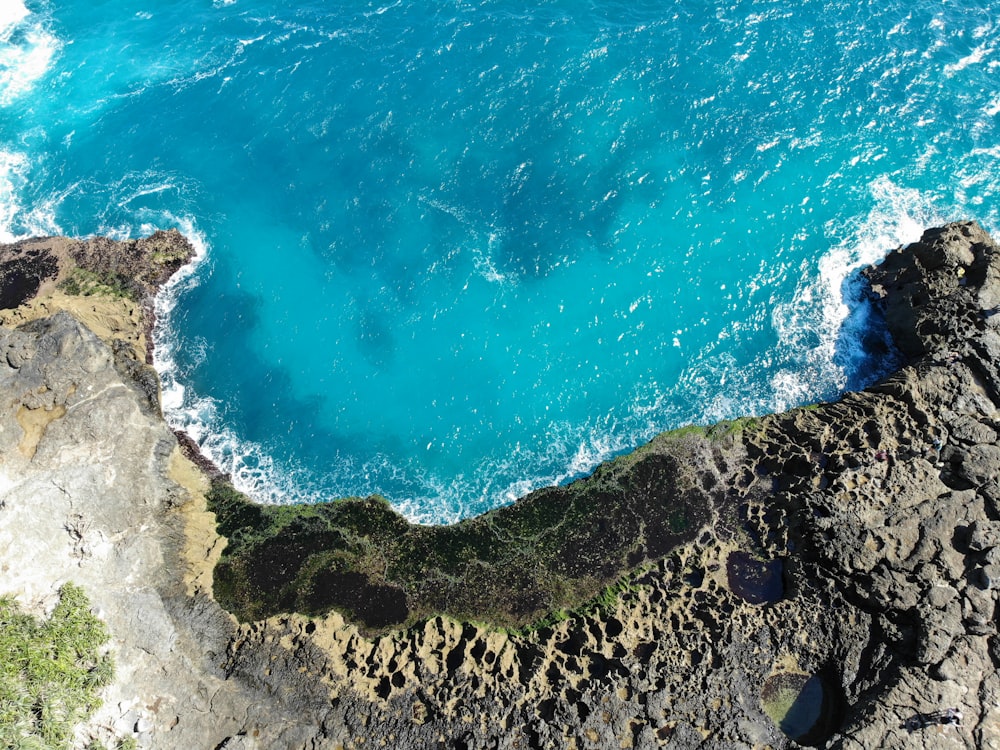 aerial view of ocean waves crashing on shore during daytime