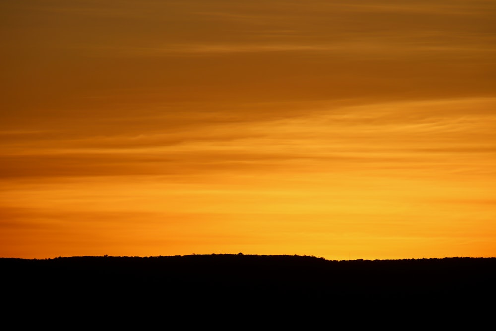 silhouette of mountain during sunset