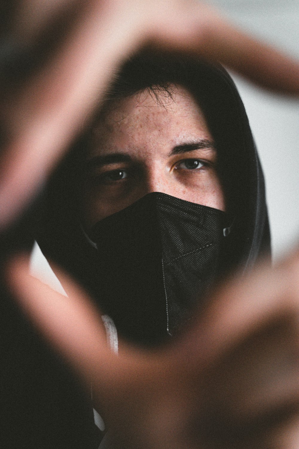 woman covering her face with black textile