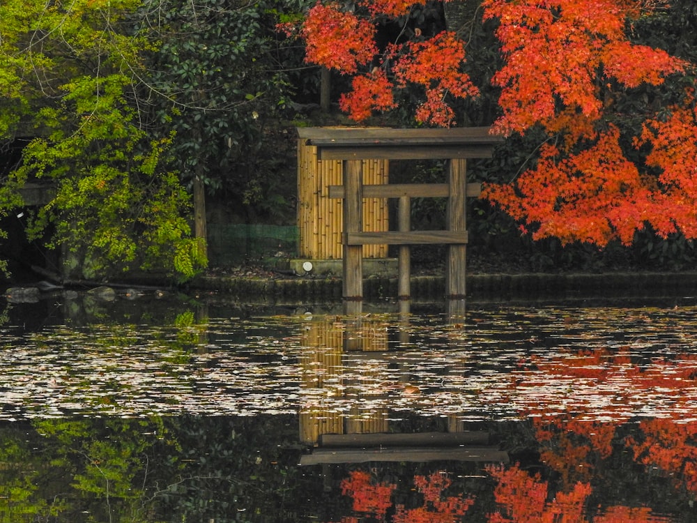 brown wooden gazebo on body of water