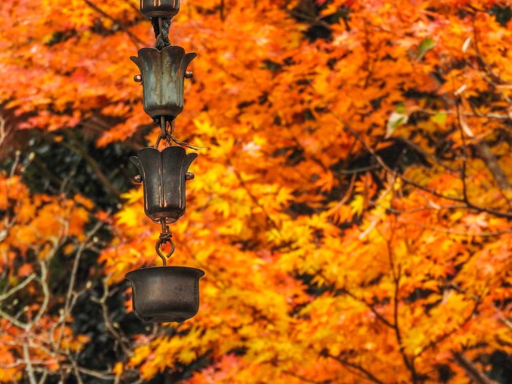 black metal candle holder with orange leaves