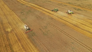 Farmers working together in a field with modern equipment.