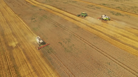 Farmers working together in a field with modern equipment.