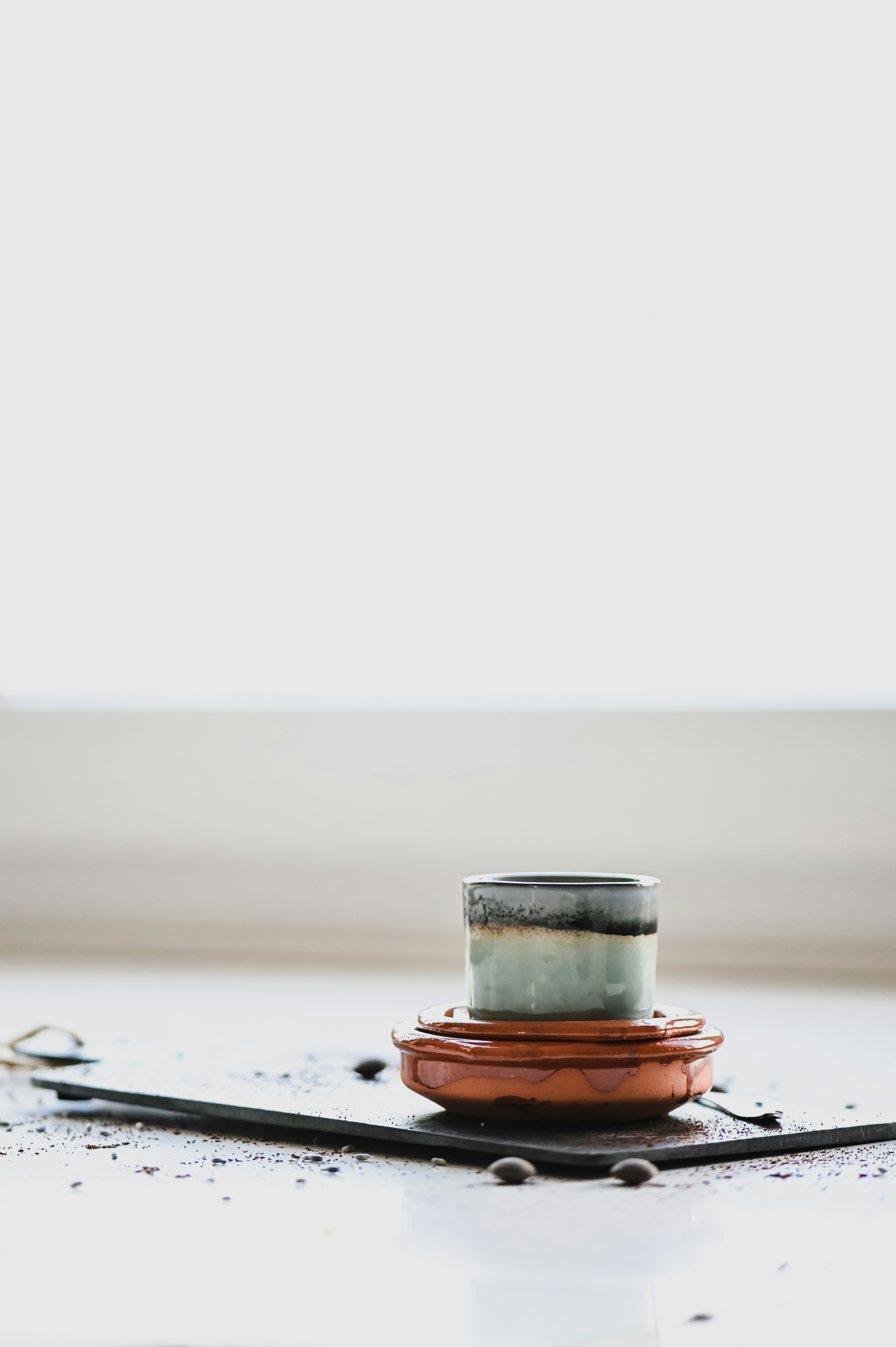 clear glass cup on white table