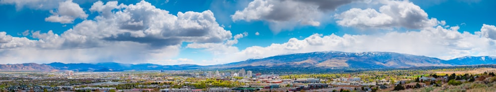 city buildings under blue sky and white clouds during daytime