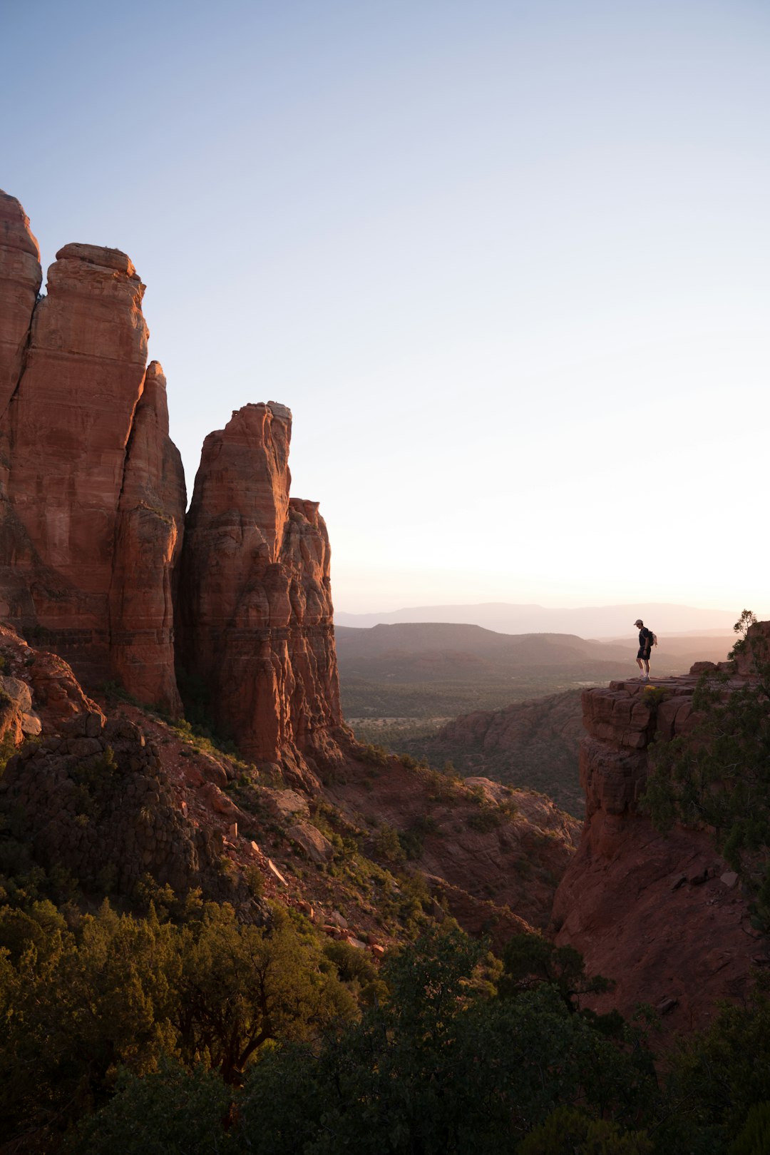 person standing on rock formation during daytime