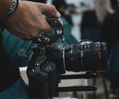 person holding black dslr camera