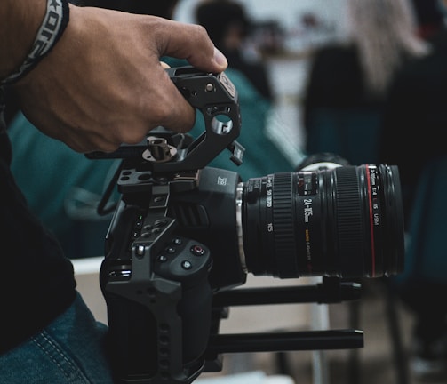 person holding black dslr camera