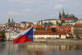 red and white concrete building near body of water during daytime