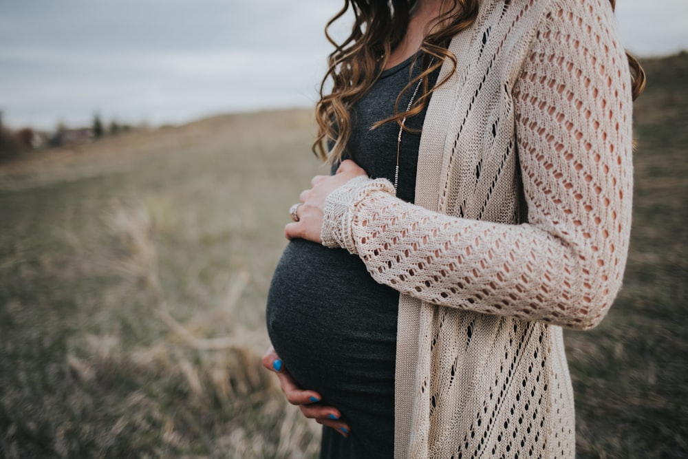 woman in white knit scarf and black dress