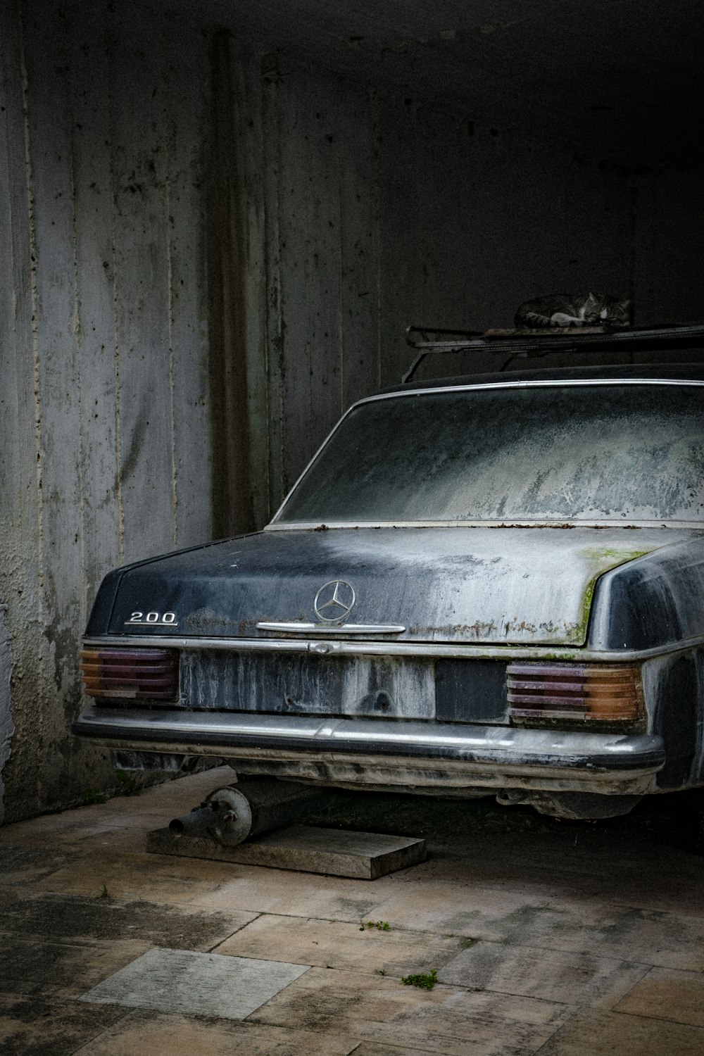 gray car parked beside wall