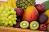 red apple fruit beside green apple and yellow fruit on brown woven basket