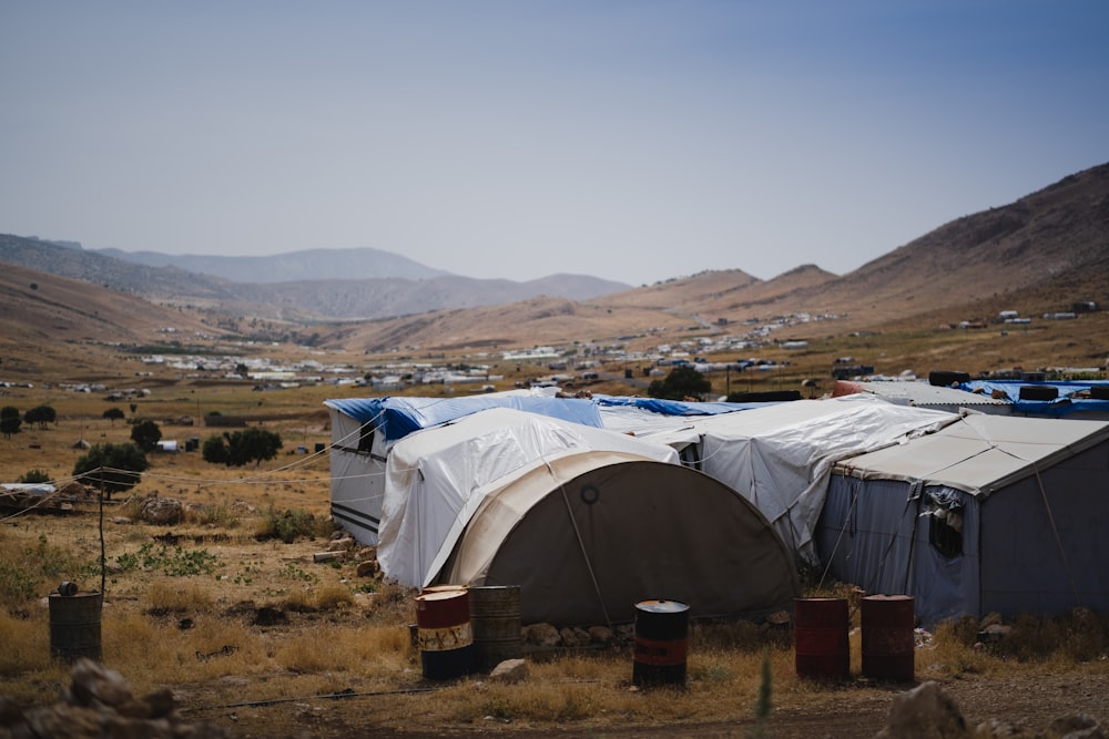 white tent on brown field during daytime