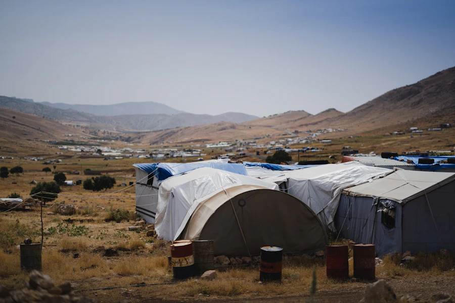Volunteers distributing supplies at a camp entrance