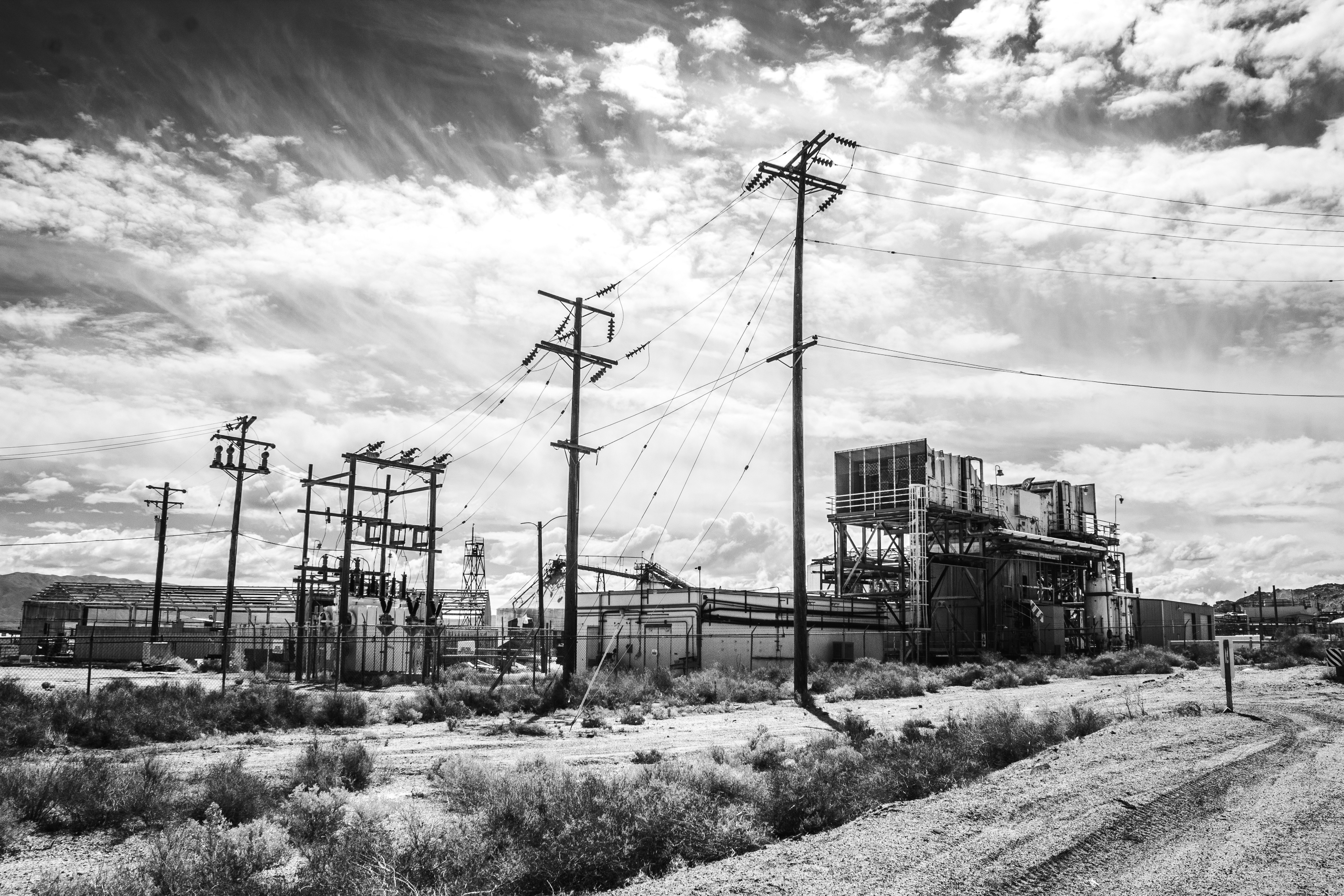 grayscale photo of electric post (Photo by Brian Wangenheim on Unsplash)