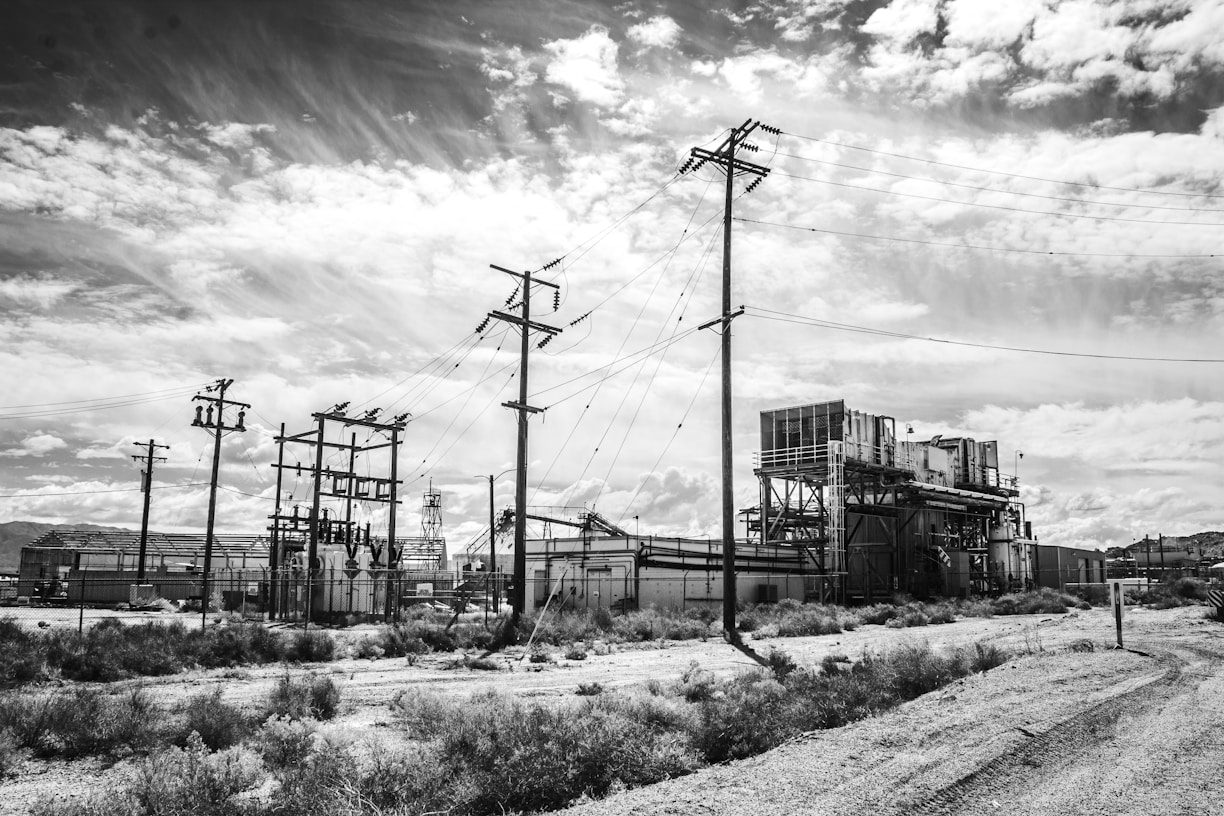grayscale photo of electric post