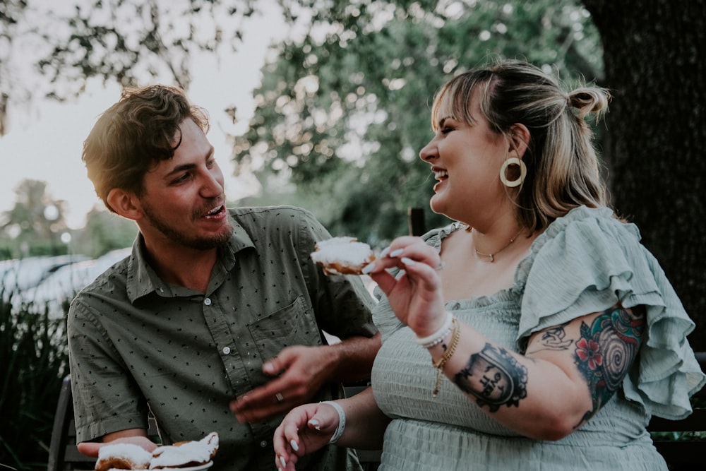 man in gray dress shirt holding girl in white dress during daytime