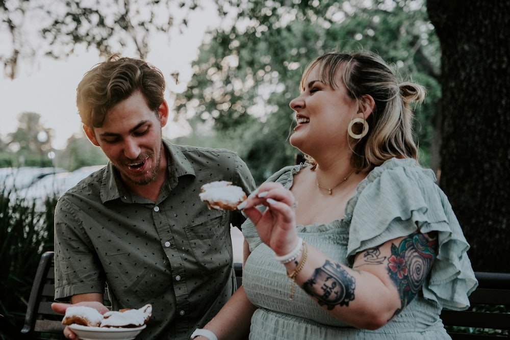 man in gray dress shirt holding girl in blue and white dress