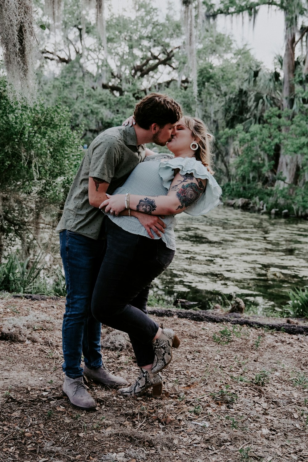 man in gray shirt carrying girl in white shirt