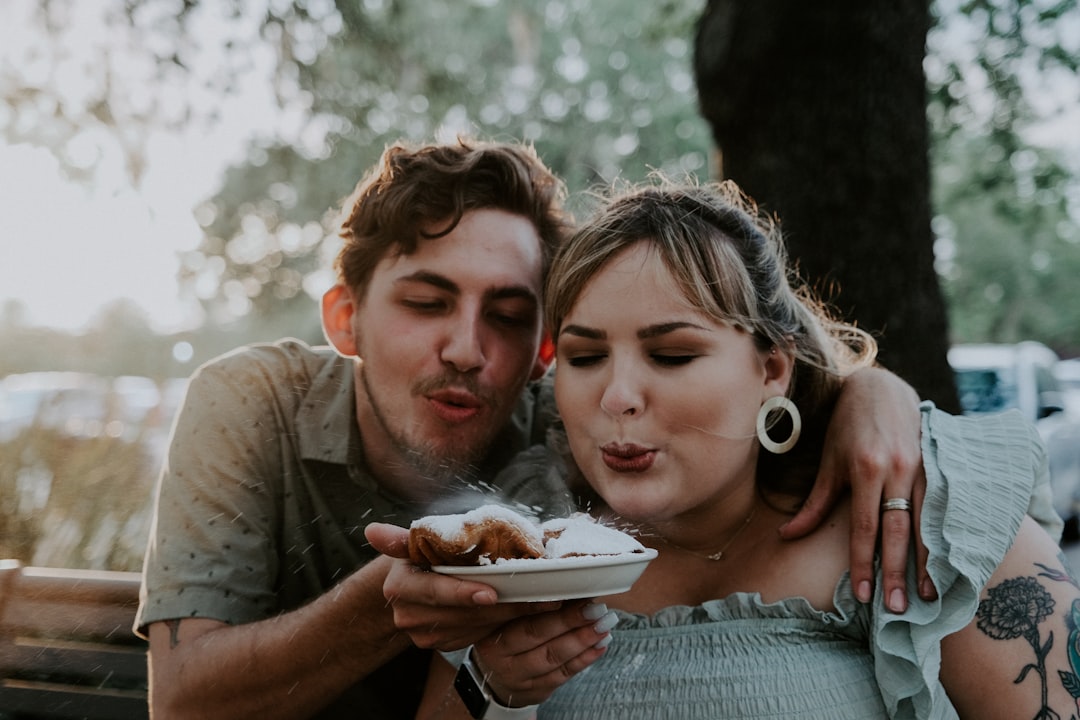 woman in gray shirt holding white ceramic plate with girl in white shirt