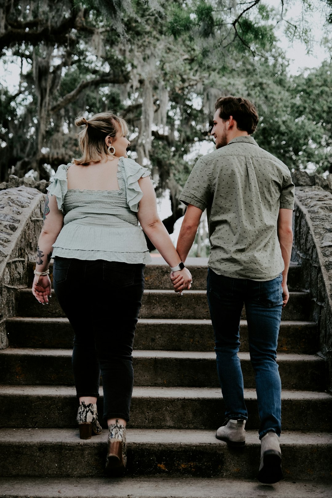 man and woman walking on stairs during daytime