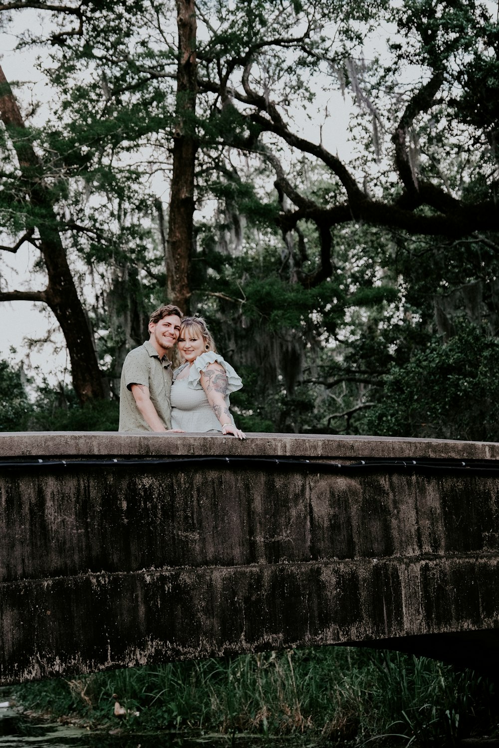 woman in white long sleeve shirt sitting on concrete bench