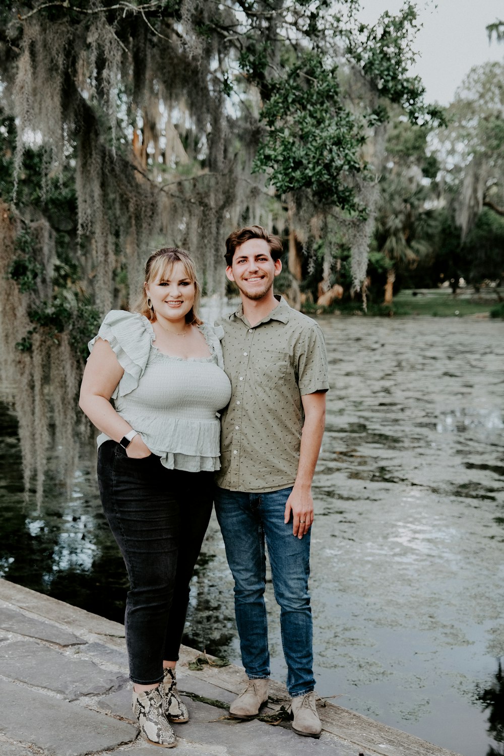 man in gray polo shirt standing beside woman in white dress