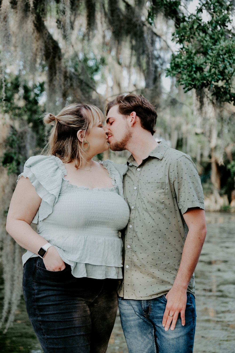 man and woman kissing during daytime