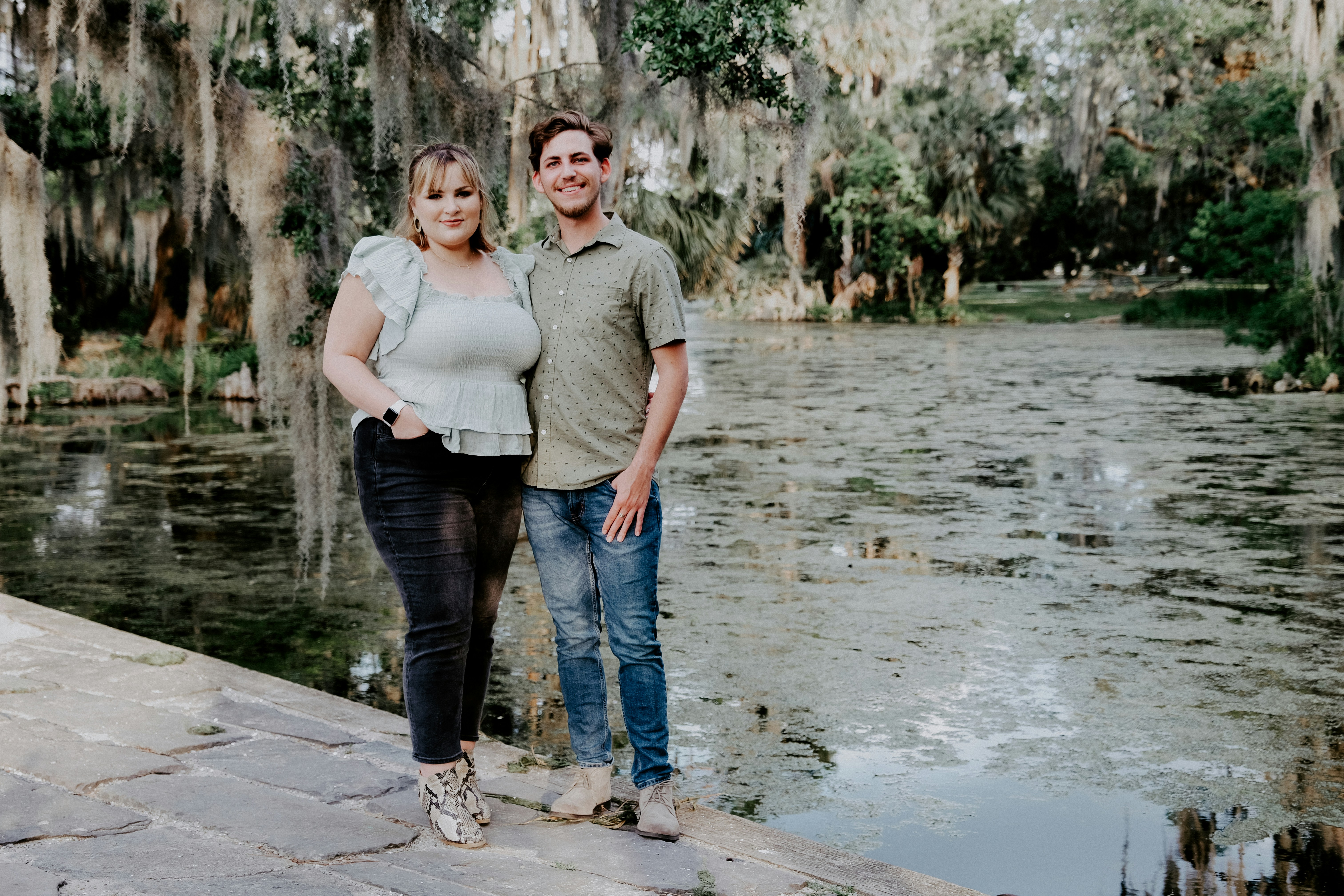 man in gray polo shirt standing beside woman in white long sleeve shirt