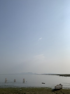 Clear waters of West Fox Lake with a fishing boat gliding near the shore.