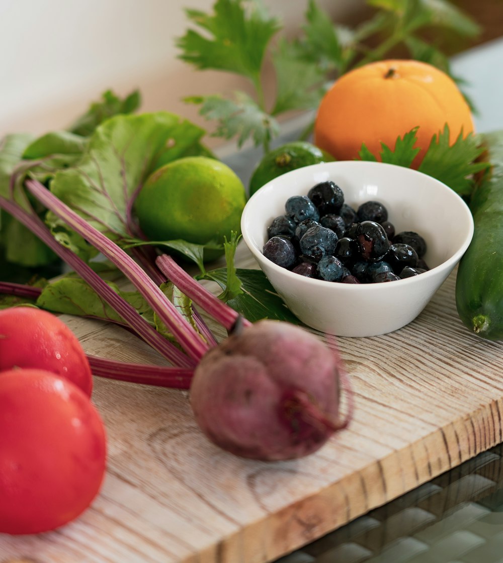 red and purple grapes on white ceramic bowl