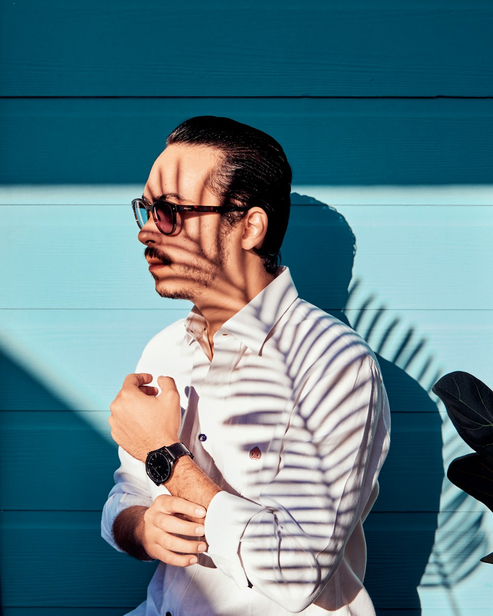 man in white and black striped dress shirt wearing black framed eyeglasses