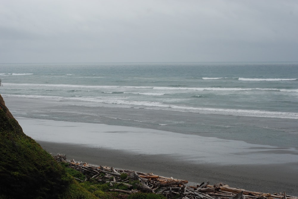 a view of a beach with waves coming in from the ocean