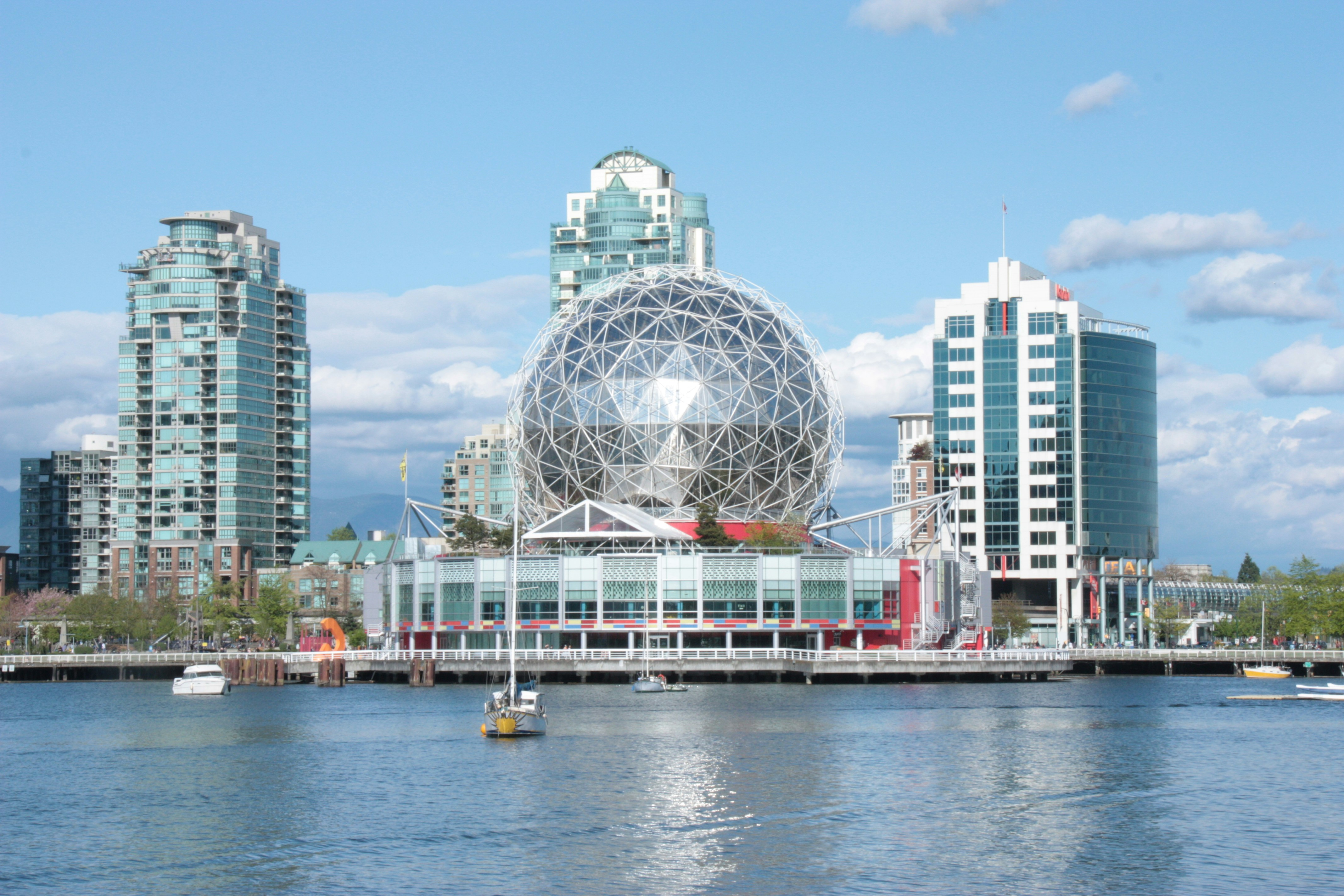 white and blue building near body of water during daytime