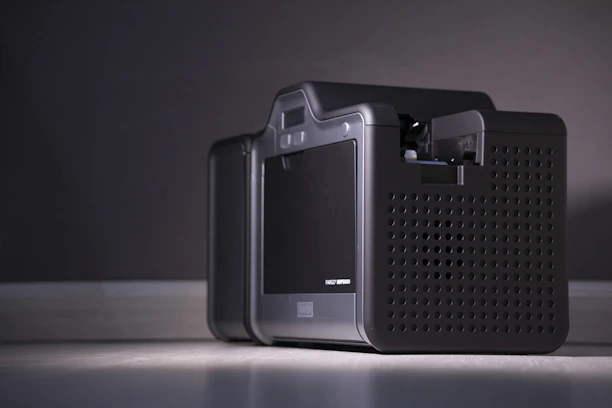 Close-up of a sleek APC nobreak device with glowing LED indicators on a modern desk