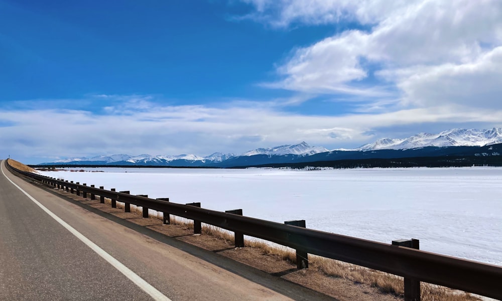 gray wooden dock on body of water under blue sky during daytime