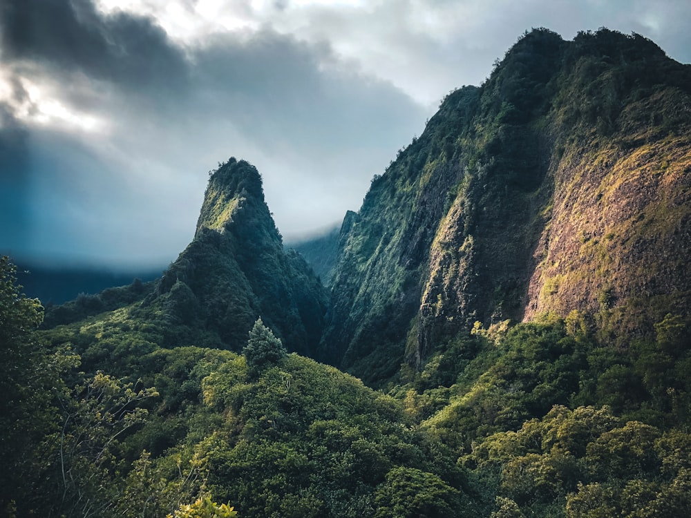 green and brown mountain under cloudy sky during daytime