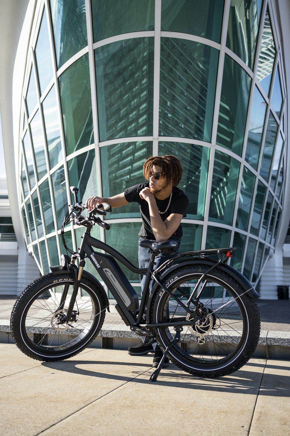 woman in black tank top riding on black bicycle