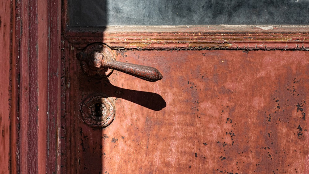 brown wooden door with gray steel door lever