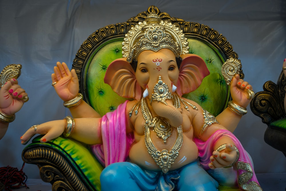 gold and purple hindu deity figurine