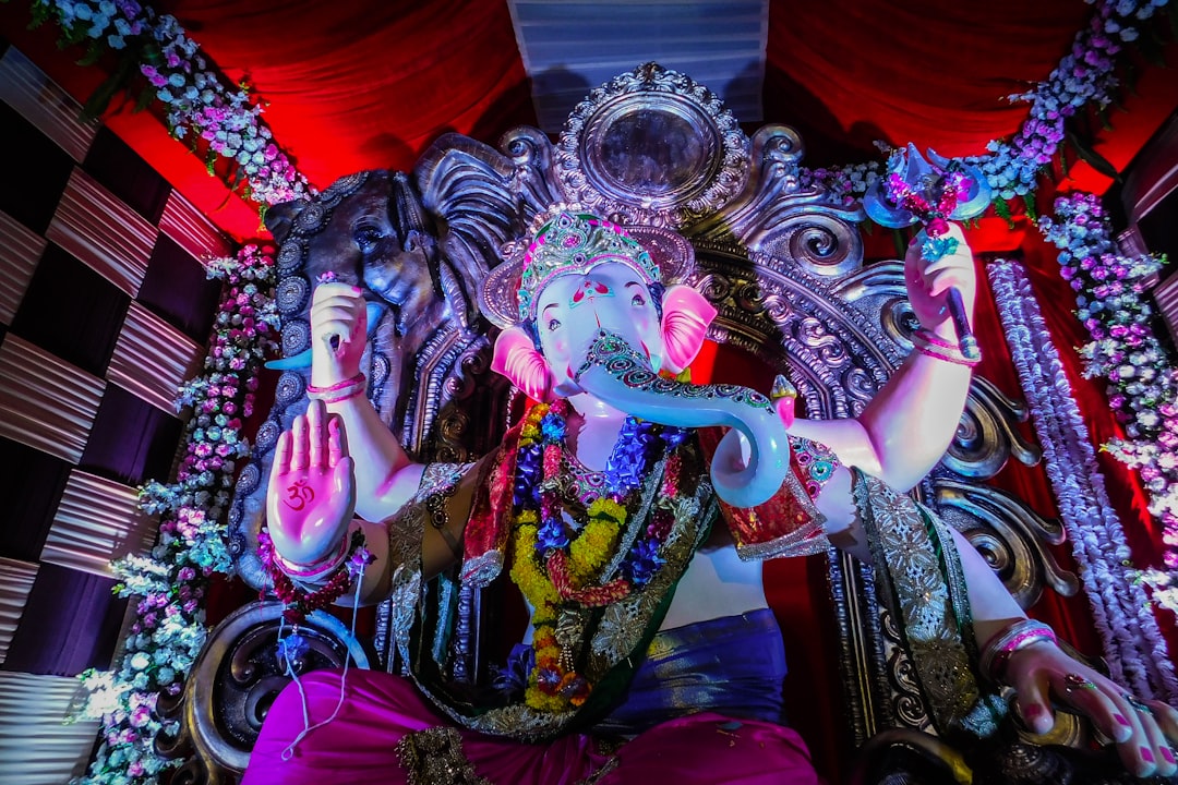 hindu deity statue on red textile, A beautiful idol of Lord Ganesha during Ganesh Chaturthi 2018 in Mumbai